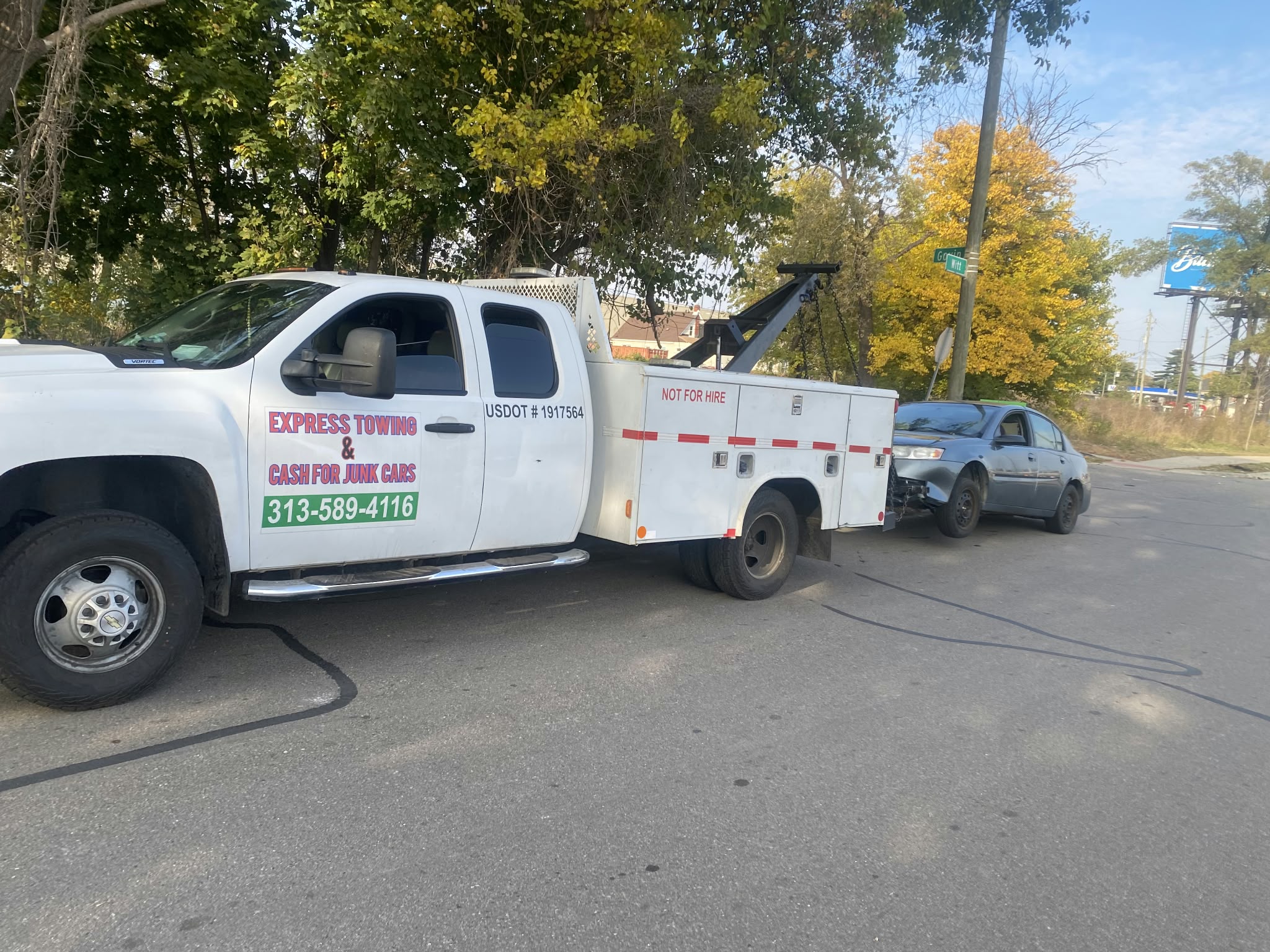 Express Towing truck hauling a sedan
